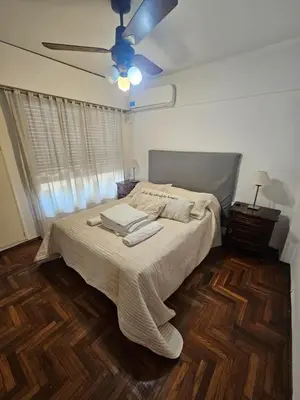 a bedroom with a bed and a ceiling fan at Mamina Apartamento in Cordoba
