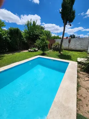 a swimming pool in the yard of a house at Posada Abuelo Miguel in Villa Cura Brochero