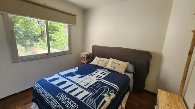 a small bedroom with a bed and a window at Departamento Salguero Nueva Córdoba in Cordoba