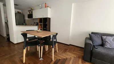 a living room with a table and a couch at Departamento Salguero Nueva Córdoba in Cordoba