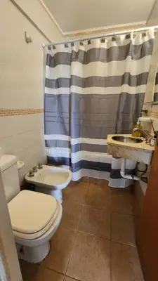 a bathroom with a toilet and a sink and a shower at Departamento Salguero Nueva Córdoba in Cordoba