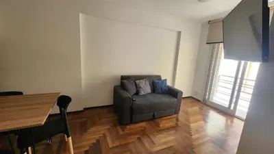 a living room with a couch and a table at Departamento Salguero Nueva Córdoba in Cordoba