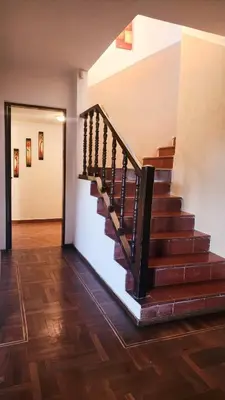 a staircase in a house with wooden floors at Casa Dos Lunas Cordoba in Cordoba