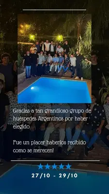 a picture of a group of people standing around a blue table at Casa Dos Lunas Cordoba in Cordoba