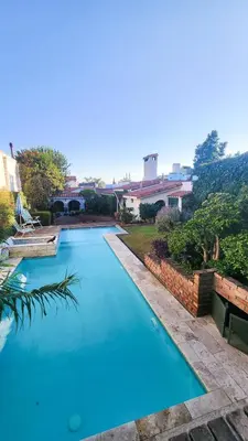 a large blue swimming pool in a yard at Casa Dos Lunas Cordoba in Cordoba