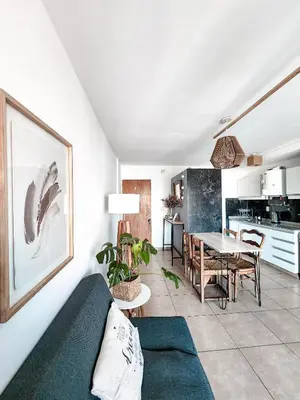a living room with a couch and a table at Dpto independencia 1446 - Pileta, Terraza, Asadores in Cordoba