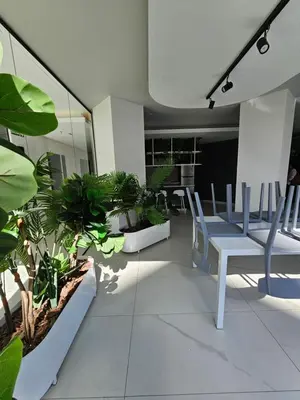 a room with a table and chairs and plants at Dpto Ambrosio Olmos 1090 - Pileta, Asadores, Terraza, Quincho in Cordoba