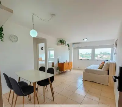a living room with a table and a couch at Departamento Antigua Cervecería - Nati - in Cordoba