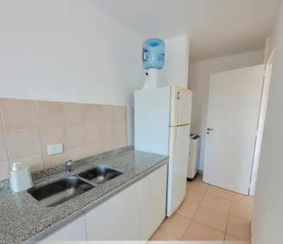 a kitchen with a sink and a white refrigerator at Departamento Antigua Cervecería - Nati - in Cordoba