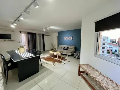 a living room with a table and a couch at Departamento Duarte Quirós in Cordoba