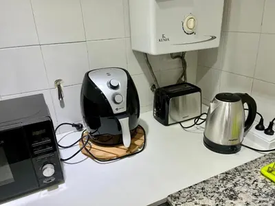 a kitchen counter with a toaster a toaster and a microwave at Departamento Duarte Quirós in Cordoba