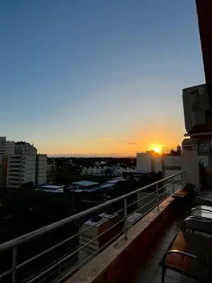 a view of the sunset from the balcony of a building at Departamento Duarte Quirós in Cordoba