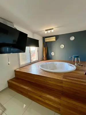 a large tub in a room with a wooden floor at Departamento Duarte Quirós in Cordoba