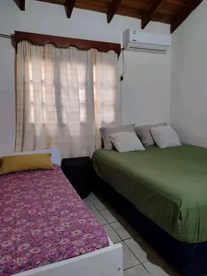 a bedroom with two beds and a window at Alquiler luque in Mina Clavero
