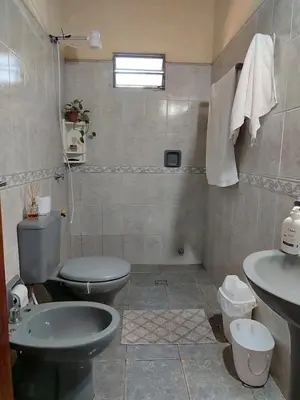 a bathroom with two toilets and a sink at Alquiler luque in Mina Clavero