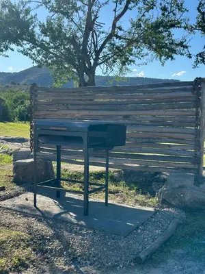 a picnic table sitting next to a wooden bench at La Loma Domo Suite in Cavalango