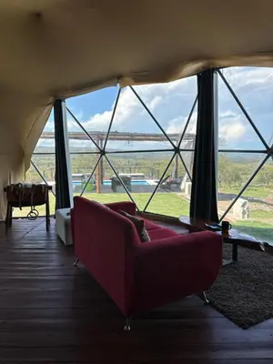 a living room with a couch in a tent at La Loma Domo Suite in Cavalango