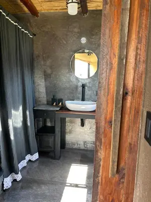 a bathroom with a sink and a mirror at La Loma Domo Suite in Cavalango
