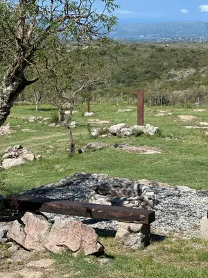 a wooden bench sitting on top of a field at La Loma Domo Suite in Cavalango