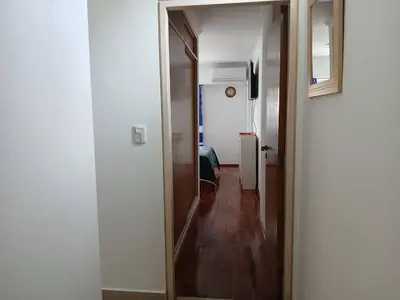 a hallway leading to a room with a mirror at Departamento con Encanto Nueva Córdoba 2 in Cordoba