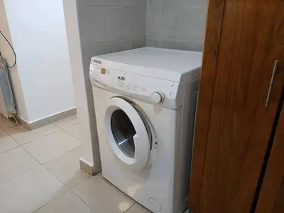 a white washer and dryer in a bathroom at Departamento con Encanto Nueva Córdoba 2 in Cordoba