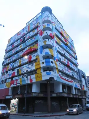 a building with cars parked in front of it at Monoambiente Centrico in Cordoba