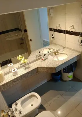 a bathroom with a sink and a toilet and a mirror at Monoambiente Centrico in Cordoba