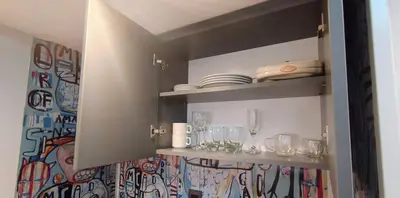 a cupboard with glasses and plates on it at Monoambiente Centrico in Cordoba