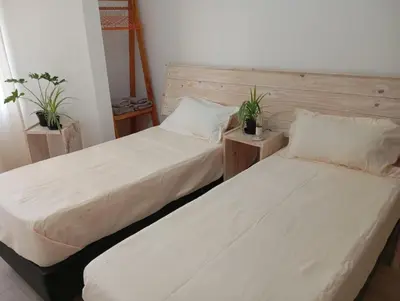 two beds sitting next to each other in a room at Monoambiente blvd San juan in Cordoba