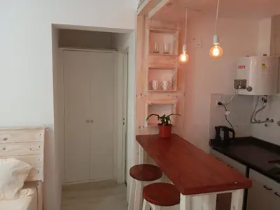 a kitchen with a wooden counter top in a room at Monoambiente blvd San juan in Cordoba