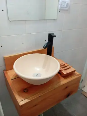 a white bowl sink on top of a wooden counter at Monoambiente blvd San juan in Cordoba