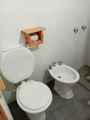 a bathroom with a white toilet and a sink at Monoambiente blvd San juan in Cordoba