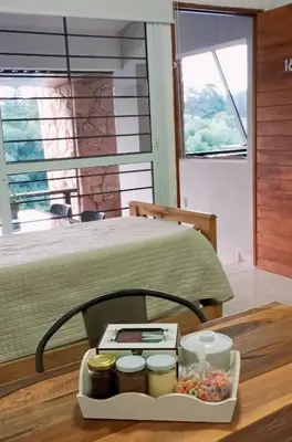 a tray of food sitting on a table next to a bed at BUENA VIDA I Apart Hotel in Villa Icho Cruz