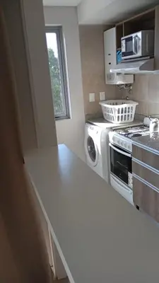 a kitchen with a stove and a white counter top at Departamento zipoli in Cordoba