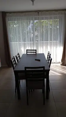 a dining room table and chairs in front of a window at Departamento zipoli in Cordoba