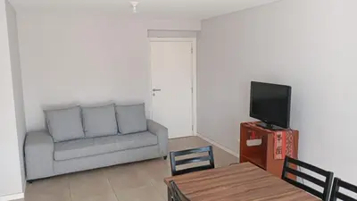 a living room with a couch and a tv at Departamento zipoli in Cordoba