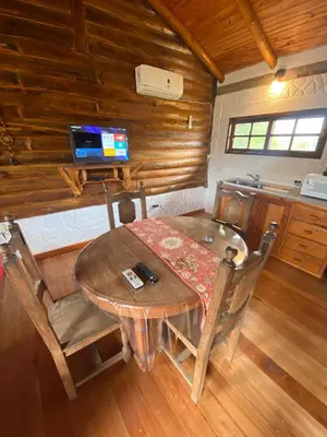 a dining room table and chairs in a cabin at Cabañas Las Serranitas 3 in Villa Parque Siquiman