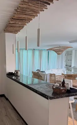 a kitchen with a counter top and a living room at Espectacular Departamento Carlos Paz in Villa Carlos Paz