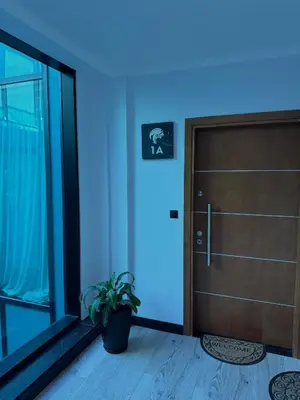 a door with a plant in a room with blue lights at Espectacular Departamento Carlos Paz in Villa Carlos Paz