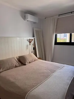 a bedroom with a large bed with a window at Espectacular Departamento Carlos Paz in Villa Carlos Paz