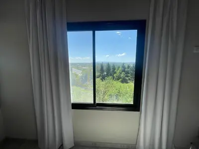 a window with white curtains in a room at Verdena in Villa Amancay