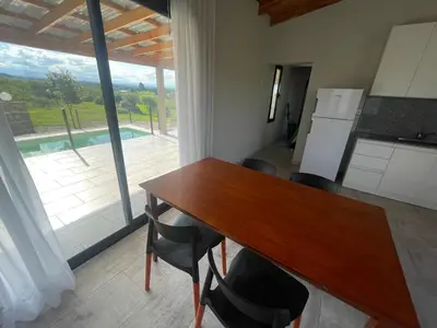 a kitchen and dining room with a table and chairs at Verdena in Villa Amancay