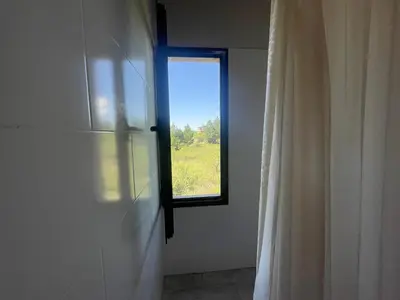 a window in a room with a shower curtain at Verdena in Villa Amancay