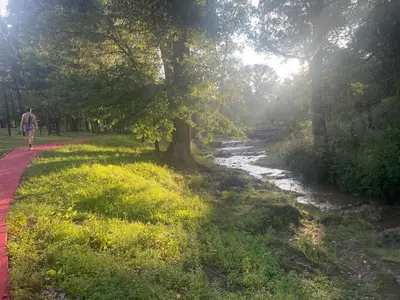 a man walking down a path next to a river at Verdena in Villa Amancay
