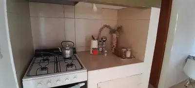 a small kitchen with a stove and a sink at MabiSil in Mina Clavero