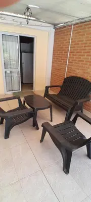 a patio with two benches and a table at MabiSil in Mina Clavero