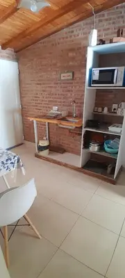 a kitchen with a counter and a table in a room at MabiSil in Mina Clavero