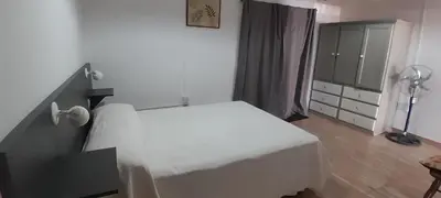 a bedroom with a white bed and a dresser at MabiSil in Mina Clavero
