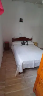 a bedroom with a white bed with a pillow on it at MabiSil in Mina Clavero