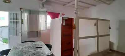 a room with a table and a refrigerator at MabiSil in Mina Clavero
